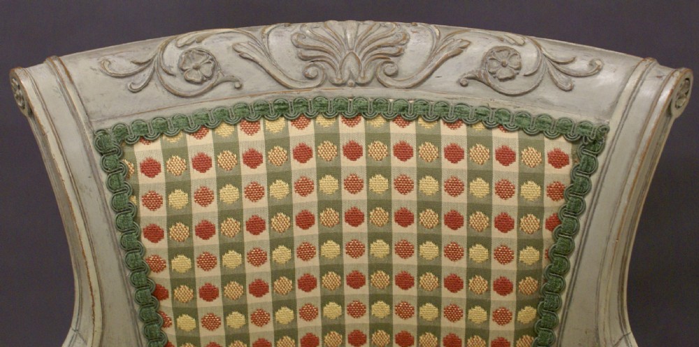 A pair of 19th-century Gustavian style painted wood armchairs with fluted legs, carved decorative trim, and patterned fabric upholstery. View II