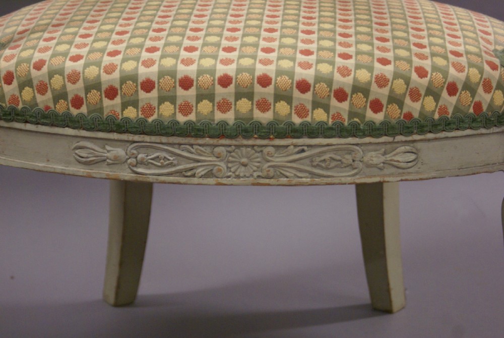 A pair of 19th-century Gustavian style painted wood armchairs with fluted legs, carved decorative trim, and patterned fabric upholstery. View VII