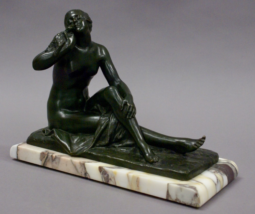 An Art Deco bronze figure holding a bird
