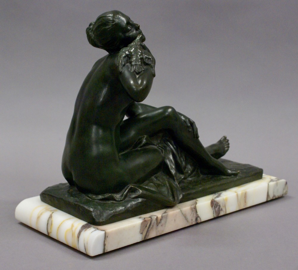 An Art Deco bronze figure holding a bird View V