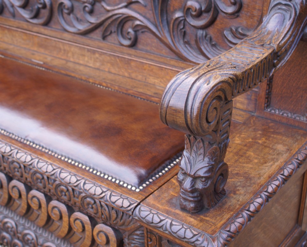 A very impressive carved oak hall bench View VIII