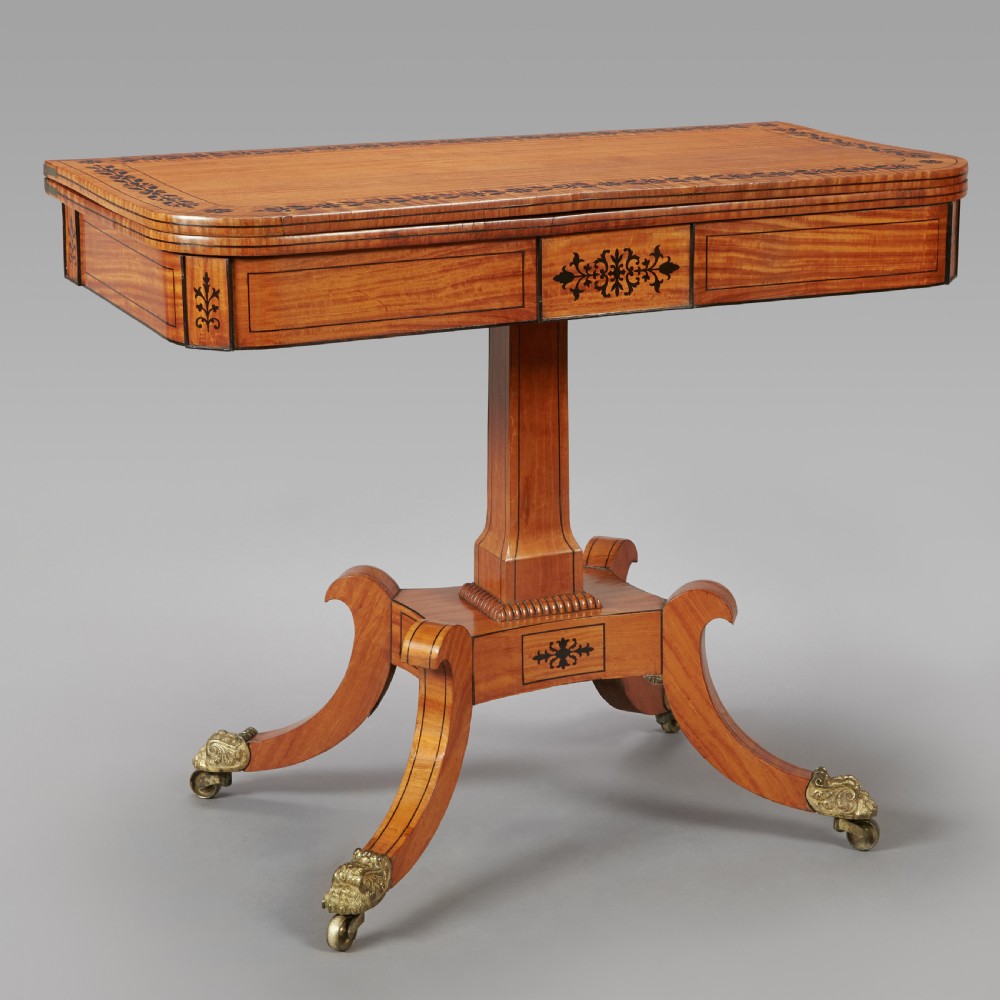 A 19th century late Regency Period satinwood and ebony inlaid pedestal card table. View II