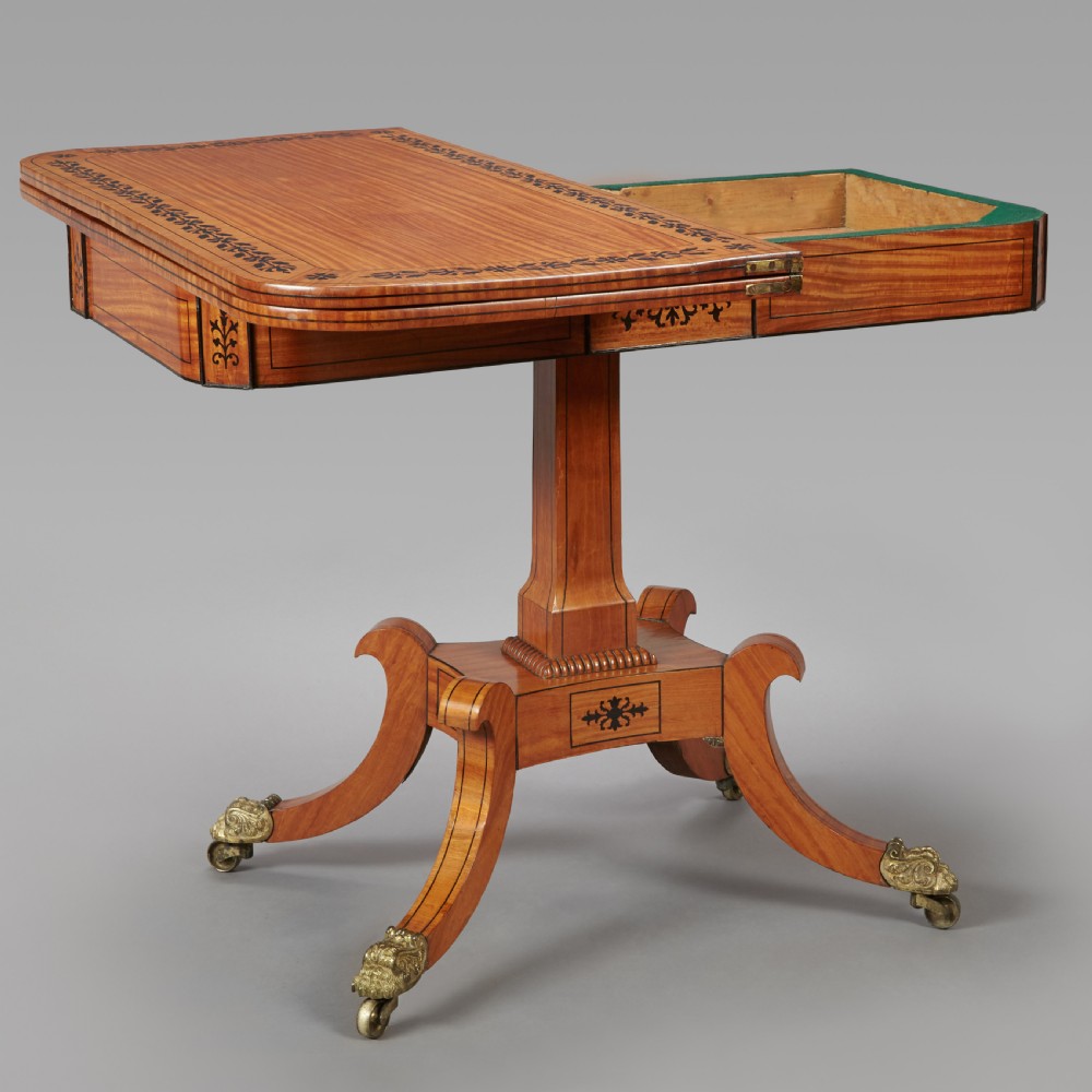 A 19th century late Regency Period satinwood and ebony inlaid pedestal card table. View III