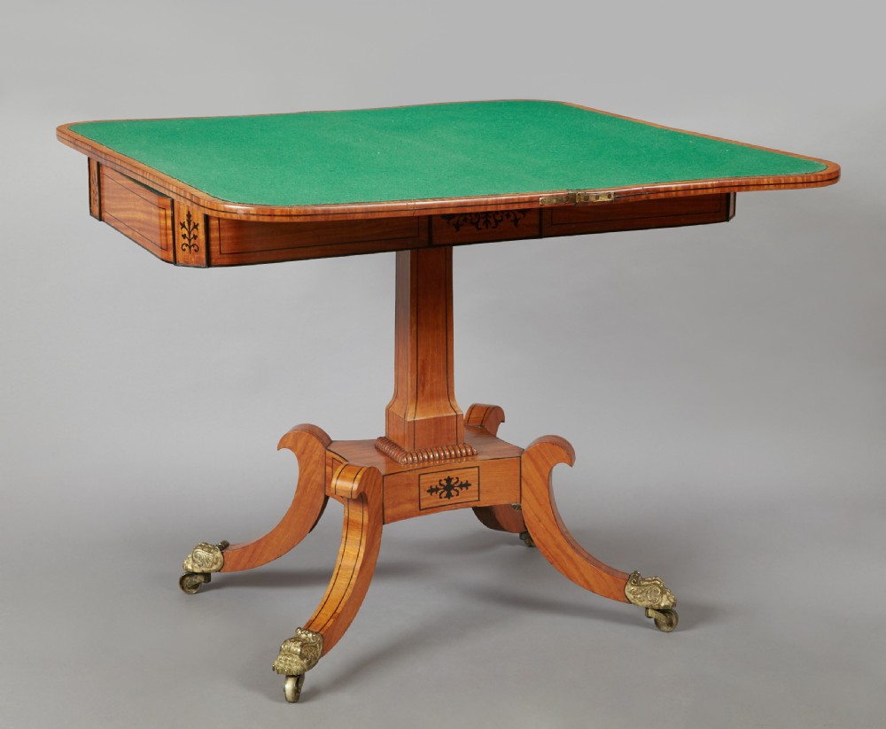 A 19th century late Regency Period satinwood and ebony inlaid pedestal card table. View IV
