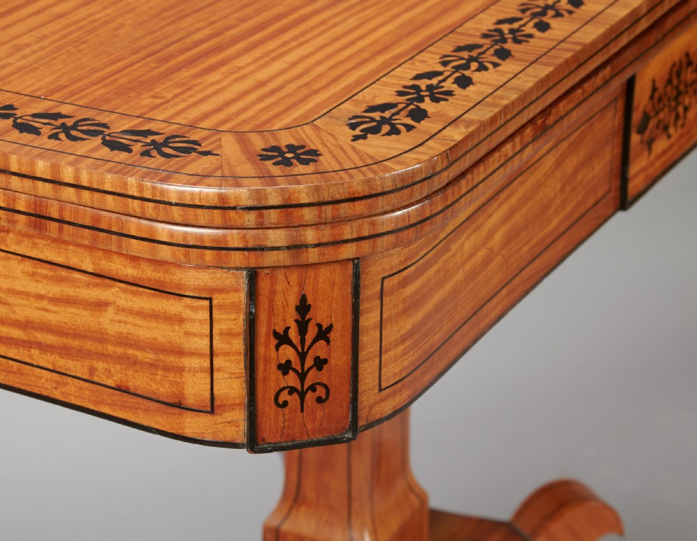A 19th century late Regency Period satinwood and ebony inlaid pedestal card table. View V