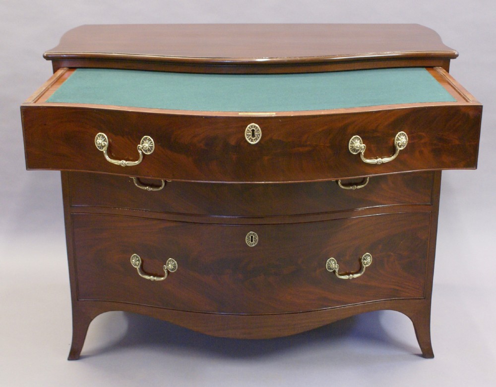 A George III serpentine chest View III