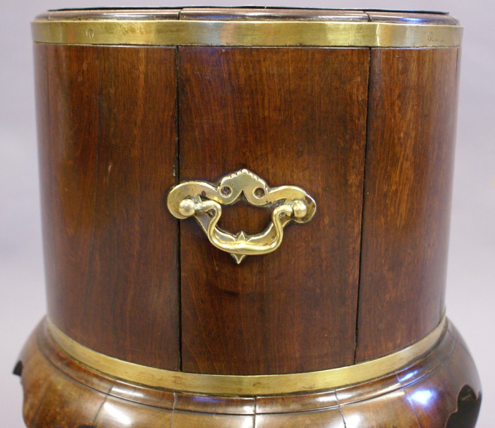 A cylindrical George II mahogany cellarette bound in brass, featuring side carry handles, a zinc liner, and cabriole legs. View III