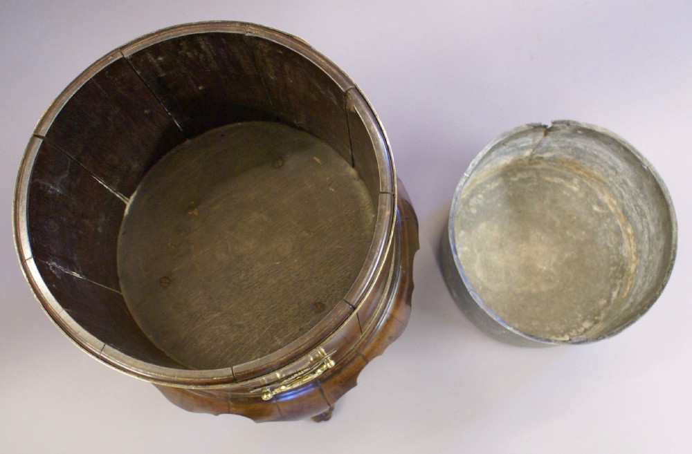A cylindrical George II mahogany cellarette bound in brass, featuring side carry handles, a zinc liner, and cabriole legs. View VII