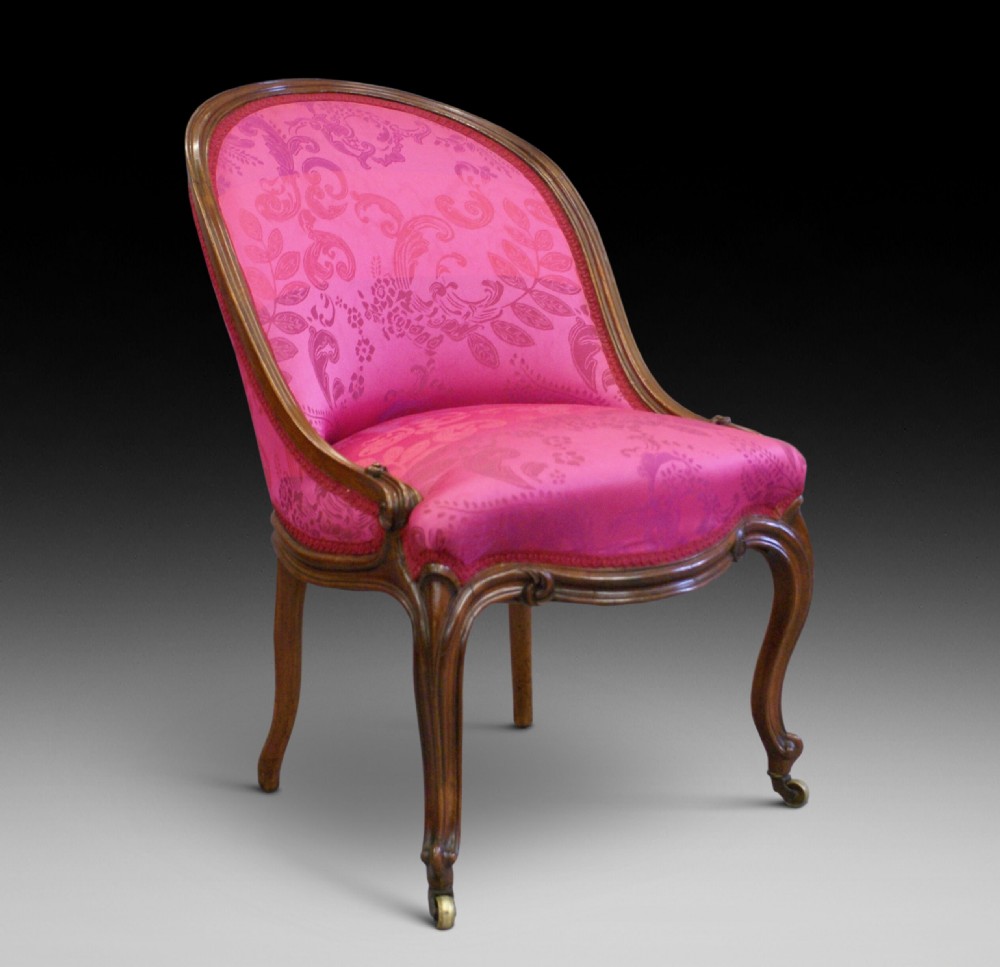 A fine early Victorian rosewood slipper chair