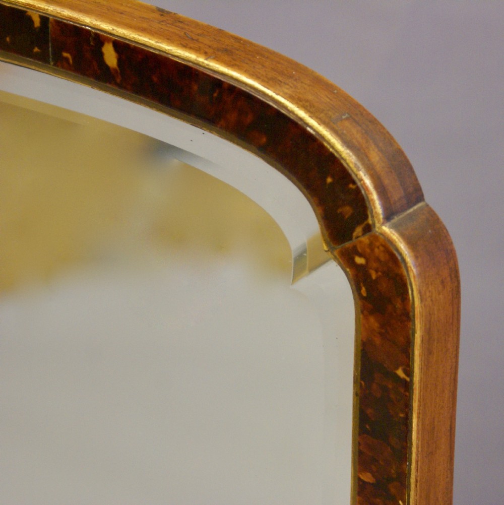 A tortoise shell wall mirror. View III