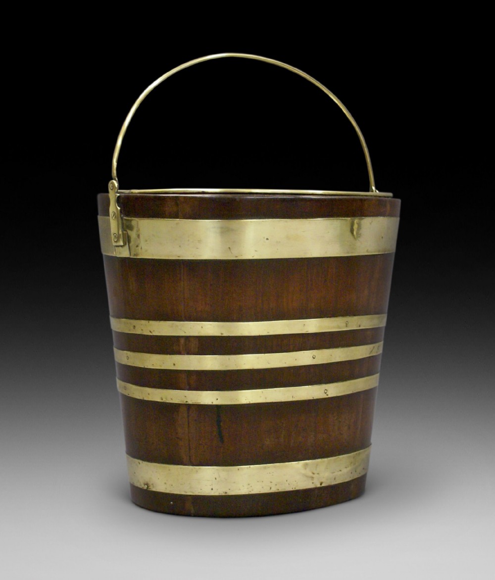 A George III mahogany and brass bound oval bucket 