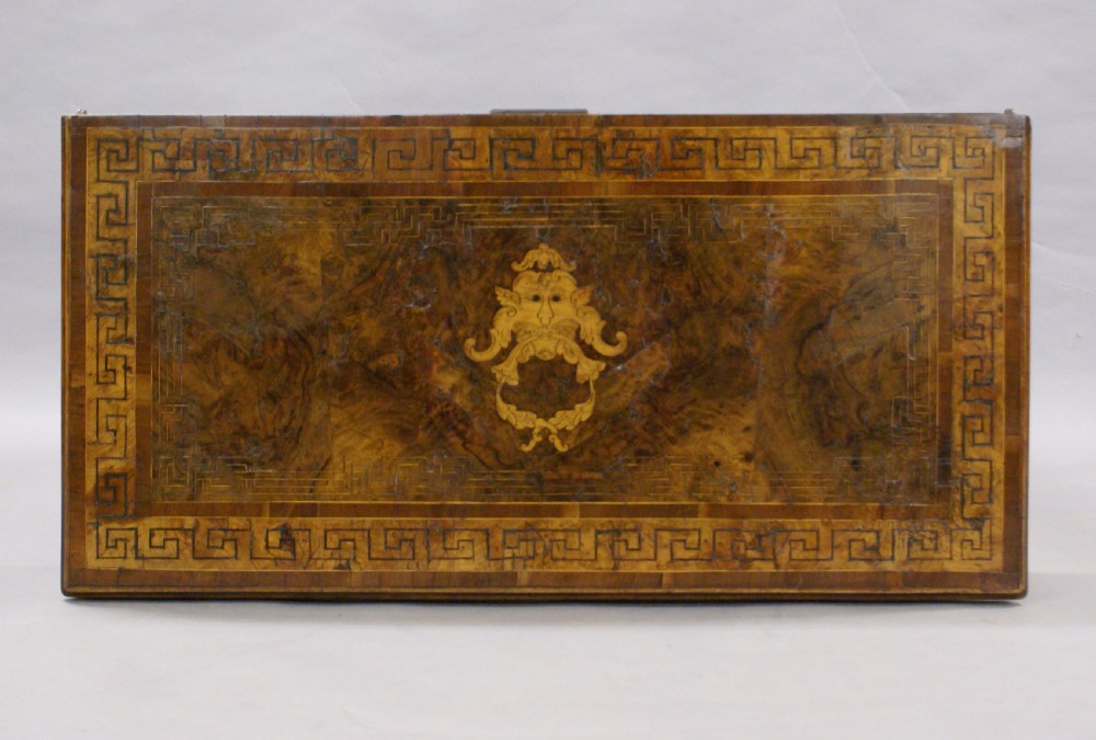 An 18th-century Italian rectangular games table crafted from warm wood, featuring geometric marquetry borders and four tapered square legs. View V