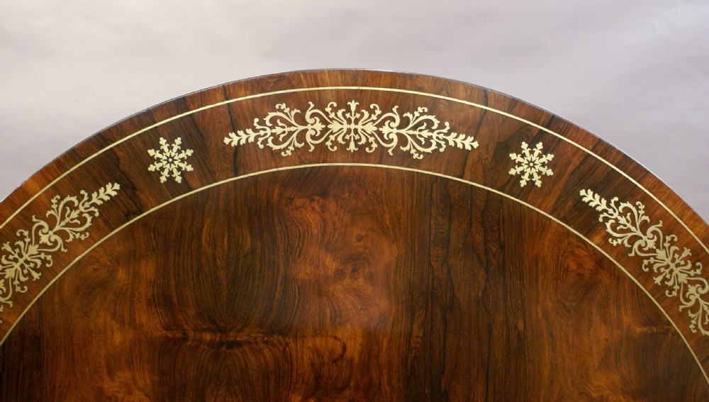 A Regency rosewood and brass inlaid centre table View II