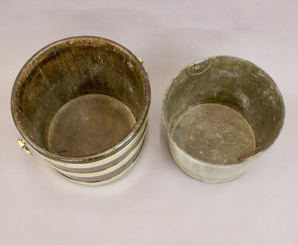 A cylindrical George III mahogany bucket with three horizontal brass bands and brass drop-ring side handles. View VI