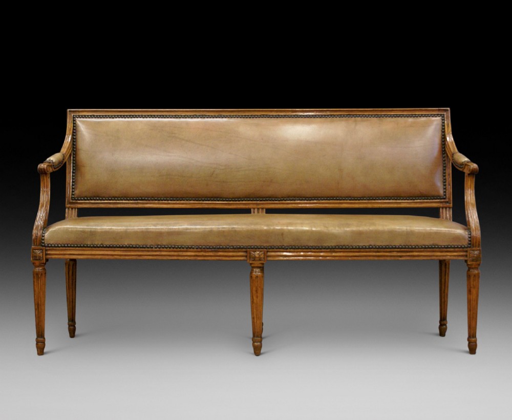 A diminutive walnut & leather bench.