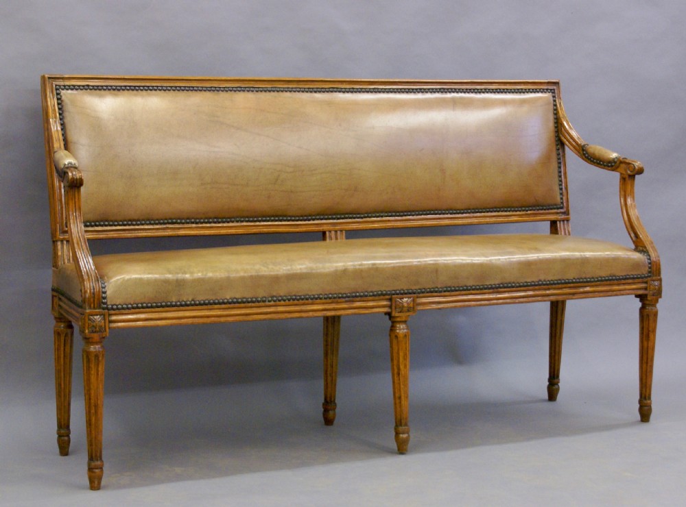 A diminutive walnut & leather bench. View II