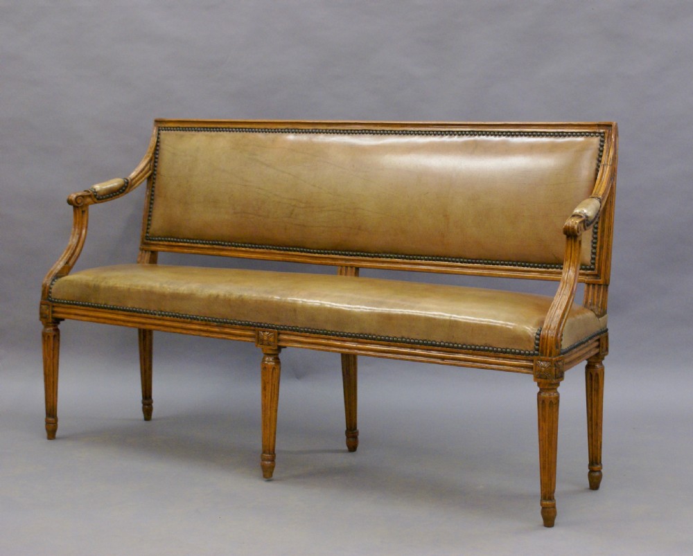 A diminutive walnut & leather bench. View III