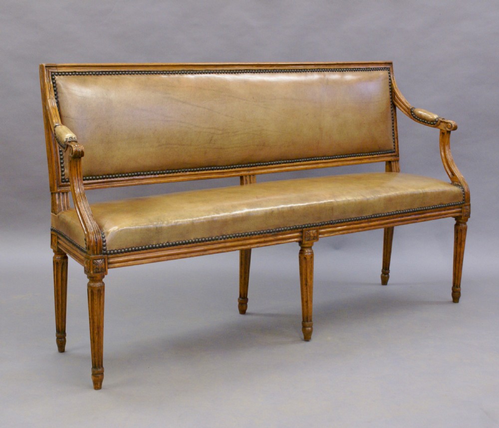 A diminutive walnut & leather bench. View V