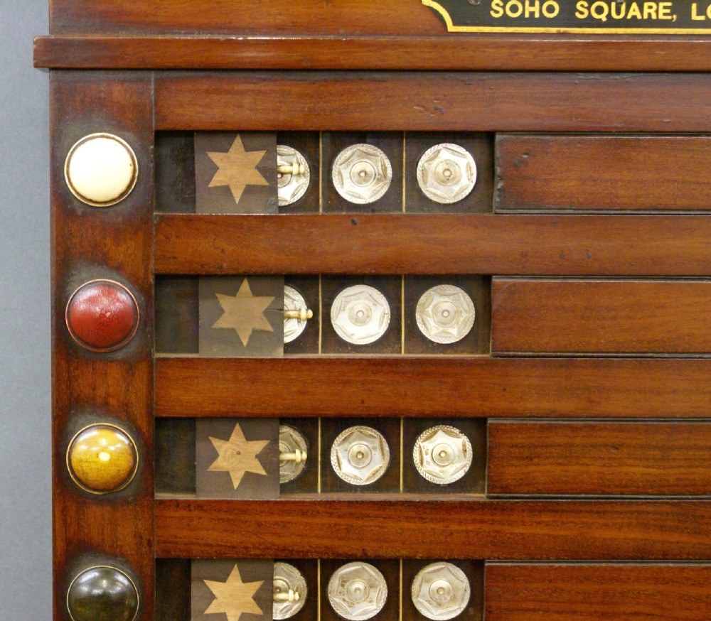 A wall-mounted nineteenth-century mahogany Life Pool scoreboard featuring horizontal wooden slides with coloured ball labels and a brass makers plaque at the top. View VII