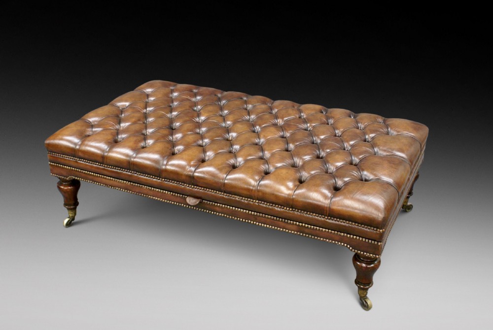 A very large leather upholstered stool