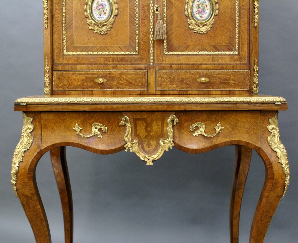 A nineteenth-century French bonheur du jour writing desk constructed from golden walnut veneer with gilded bronze mounts, cabriole legs, and inset hand-painted porcelain plaques. View VII