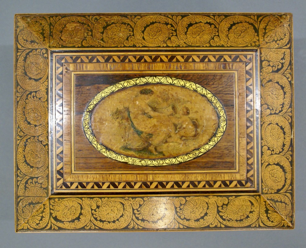A rectangular dark rosewood Regency sewing box featuring brass ball feet, lion-mask side ring handles, and floral marquetry inlay across the lid. View II