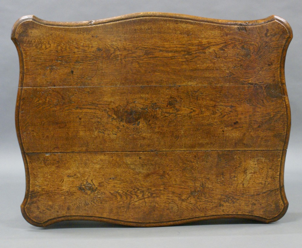 An 18th-century carved oak centre table featuring cabriole legs and detailed floral frieze carving. View IV