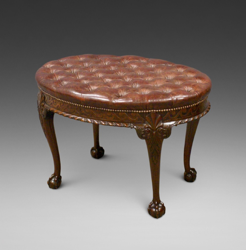 A large carved mahogany oval stool