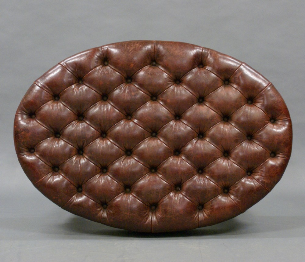 A large carved mahogany oval stool View II