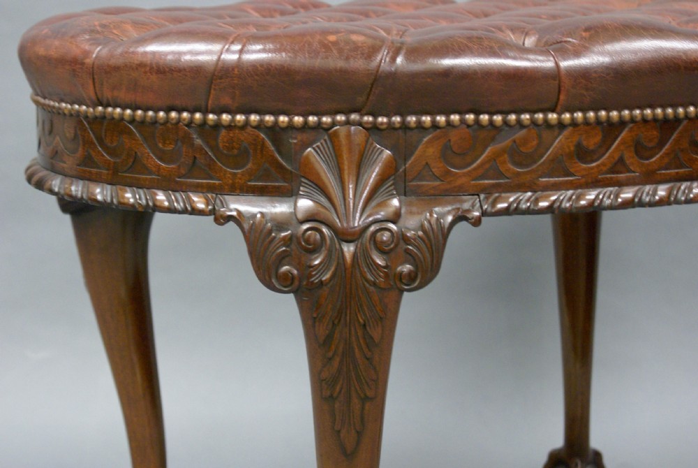 A large carved mahogany oval stool View III