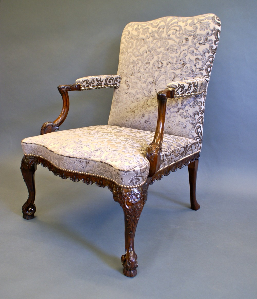 A George II style mahogany Gainsborough library armchair upholstered in a patterned taupe fabric with carved cabriole legs and scroll feet. View VI