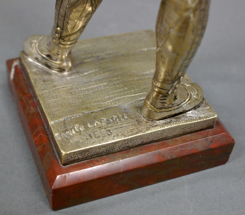 A bronze figure of a Harlequin by Emile Laporte View VI