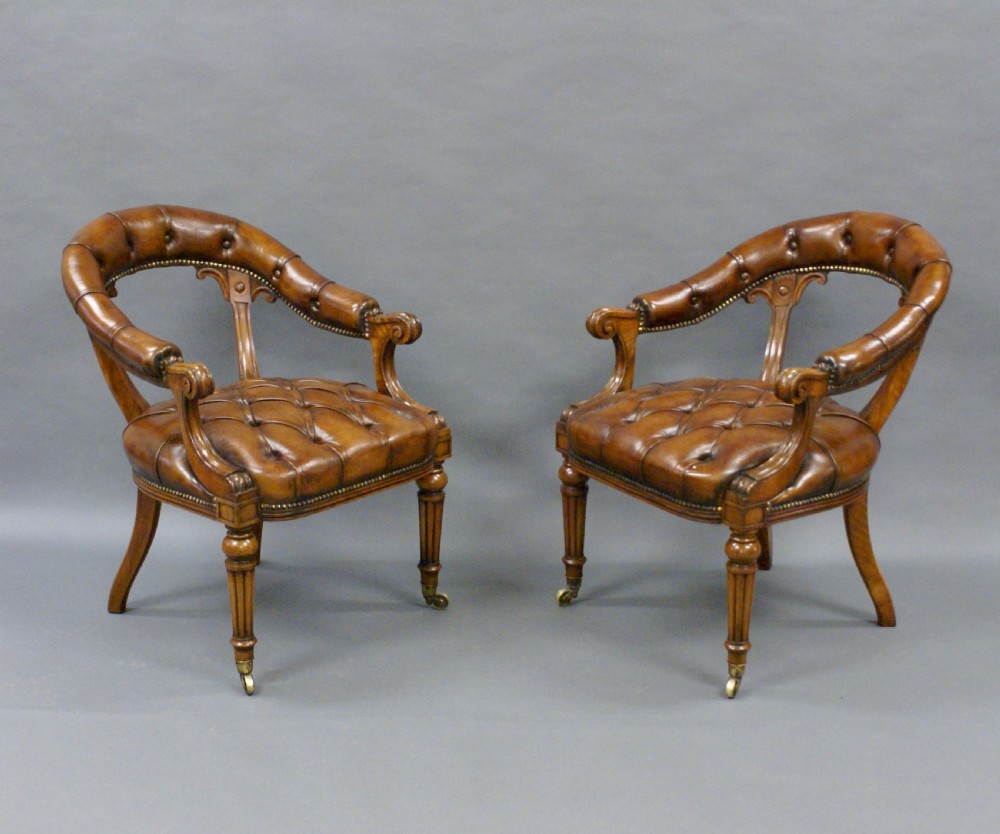 A fine pair of walnut library arm chairs View VI