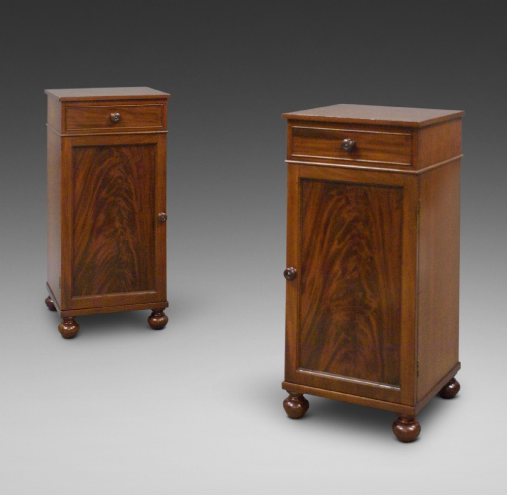 A pair of flame mahogany bedside cabinets
