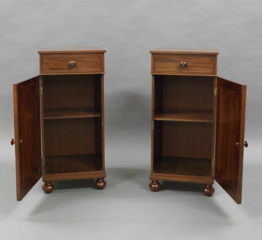 A pair of flame mahogany bedside cabinets View V