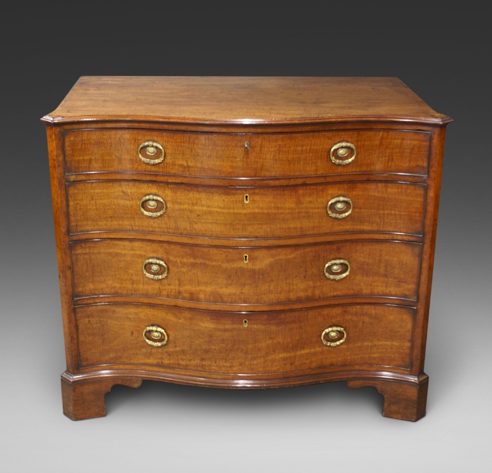 A George III mahogany serpentine chest