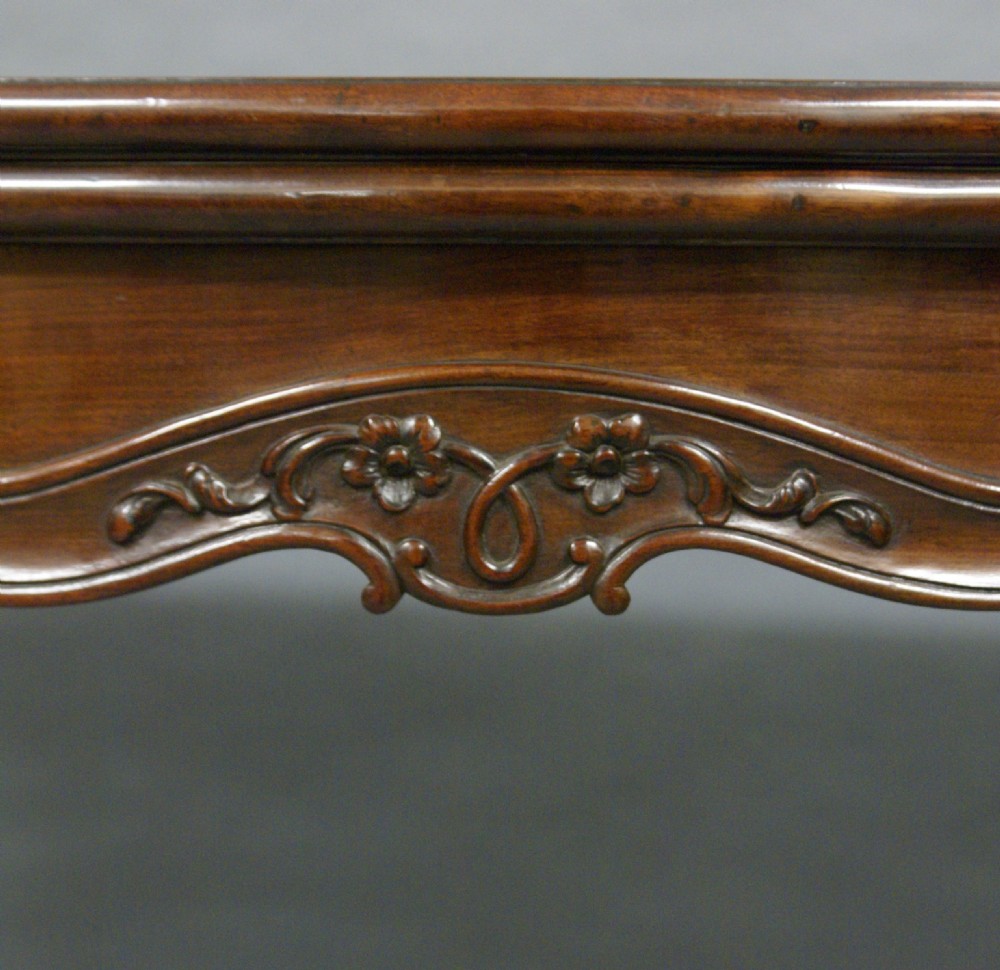 A dark mahogany Hepplewhite period serpentine-front card table featuring carved cabriole legs and scroll feet. View II