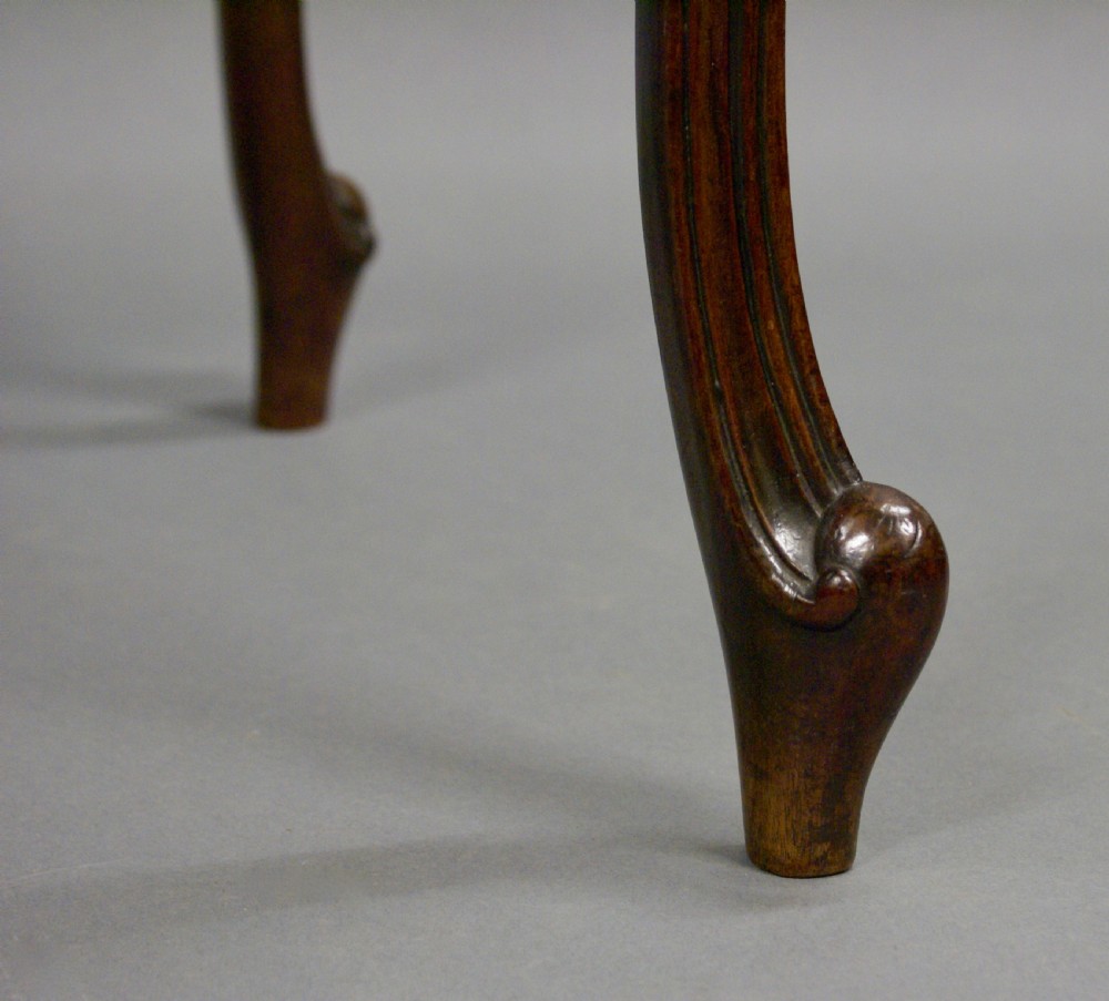 A dark mahogany Hepplewhite period serpentine-front card table featuring carved cabriole legs and scroll feet. View VI