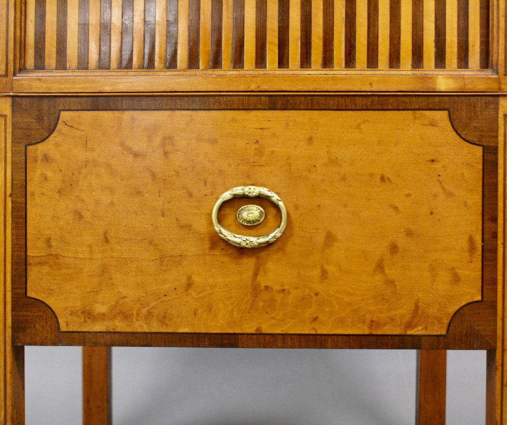 An 18th-century George III satinwood tray-top commode featuring a tambour sliding front, cutout gallery handles, single lower drawer, and straight square legs. View VII