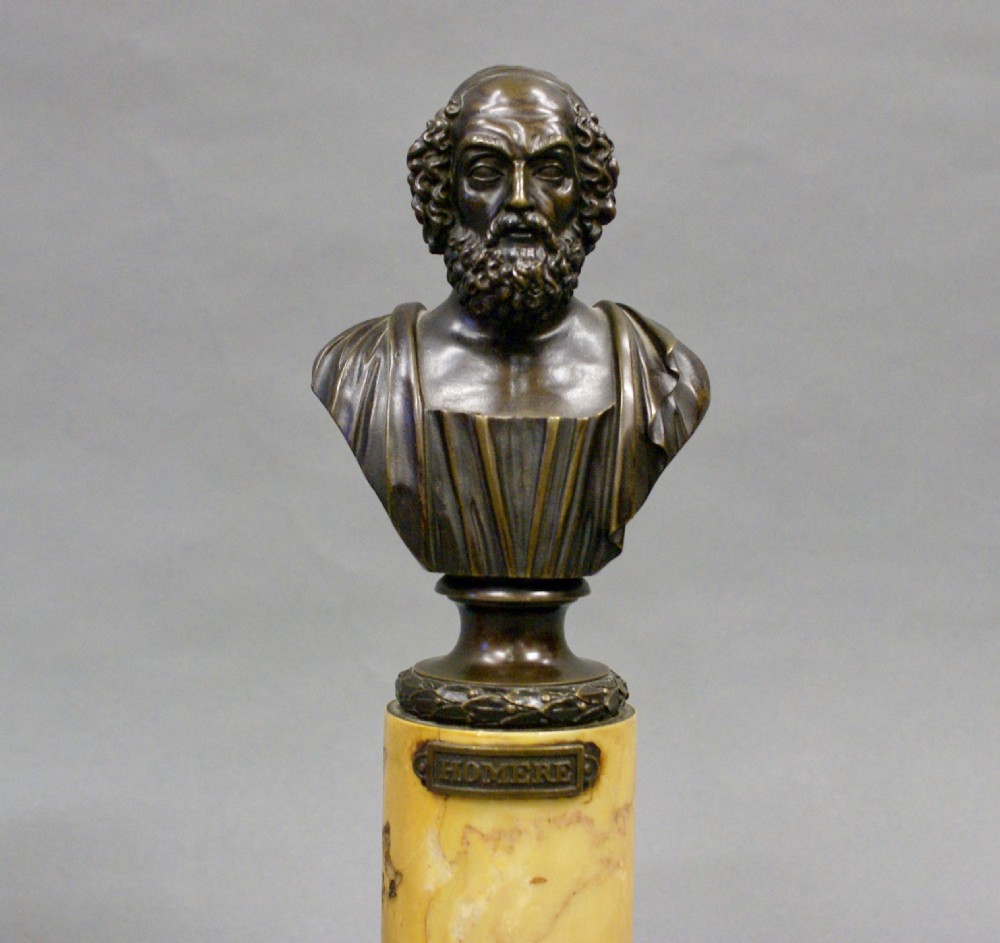 A pair of classical bronze portrait busts of bearded and curled-haired male figures set atop cylindrical yellow marble plinths with square bases. View III
