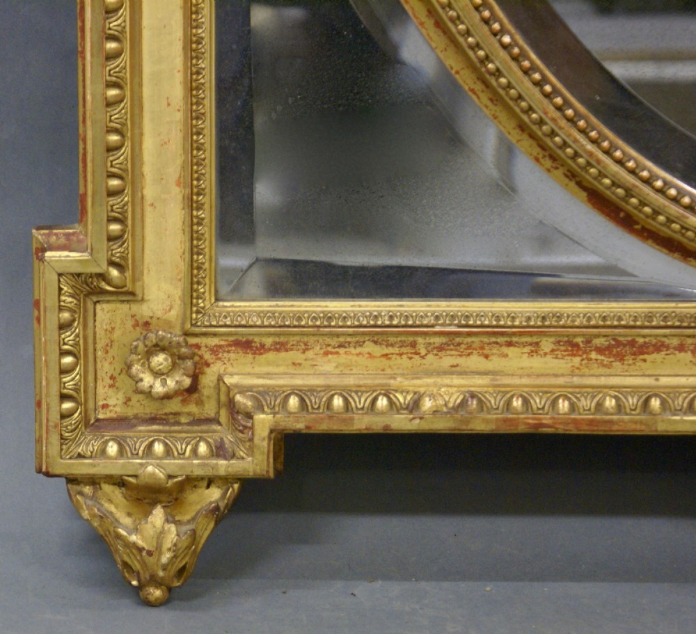A rectangular French gilt wall mirror featuring an oval inner bevelled frame, laurel foliage crest, and a top medallion containing a profile cameo. View V