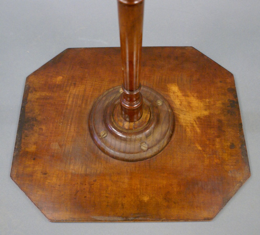 A Regency satinwood tripod table with an octagonal top, turned central stem, and three down-swept legs against a grey gradient background. View VII