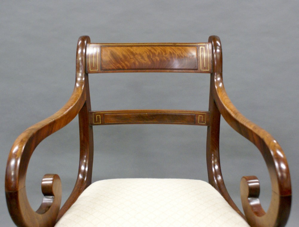 A pair of Regency mahogany brass inlaid arm chairs View III