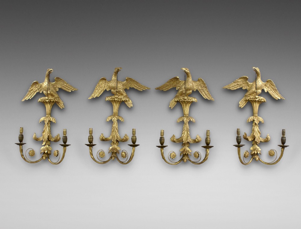 A set of gilt wood spread eagle wall lights