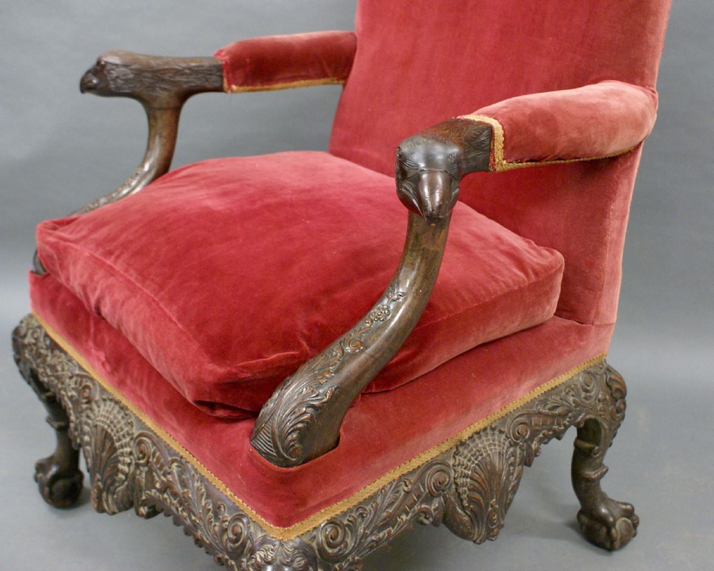 A Georgian style carved mahogany library armchair upholstered in red velvet with eagle head armrests and ball-and-claw feet. View III