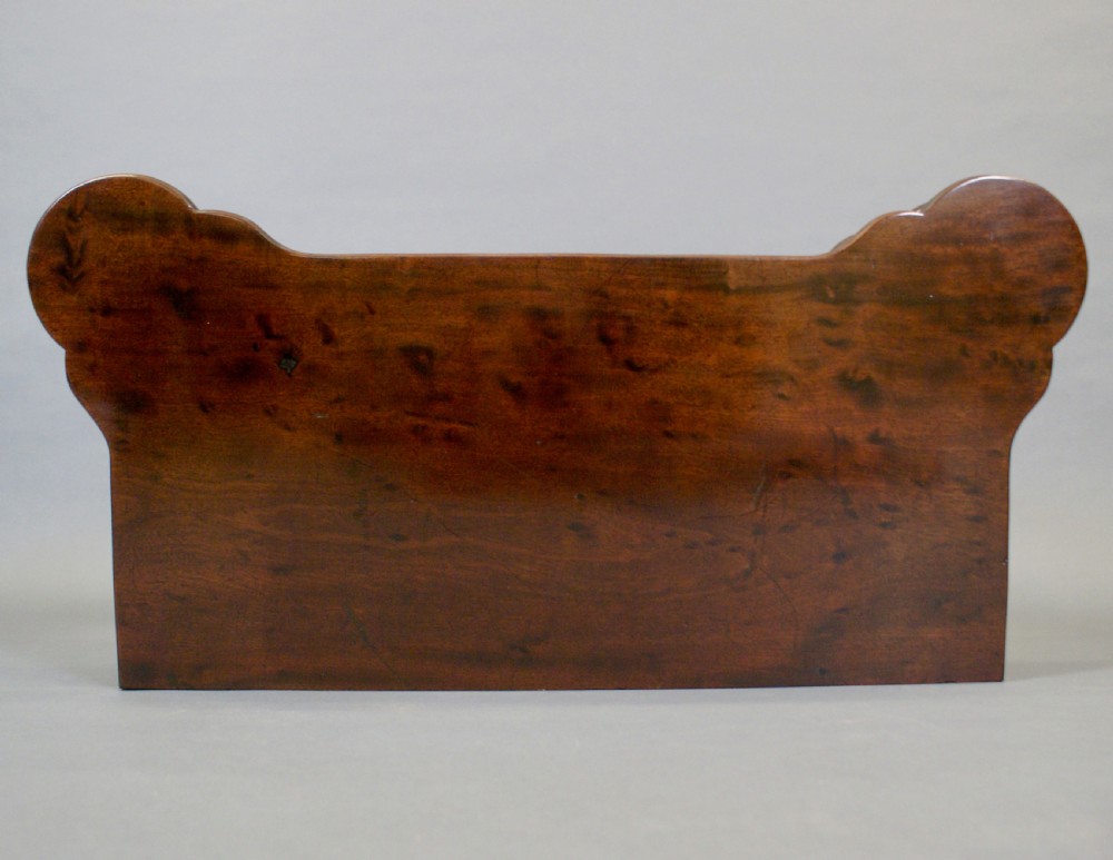 A George II mahogany fold-over tea table featuring a serpentine top and carved cabriole legs. View VIII