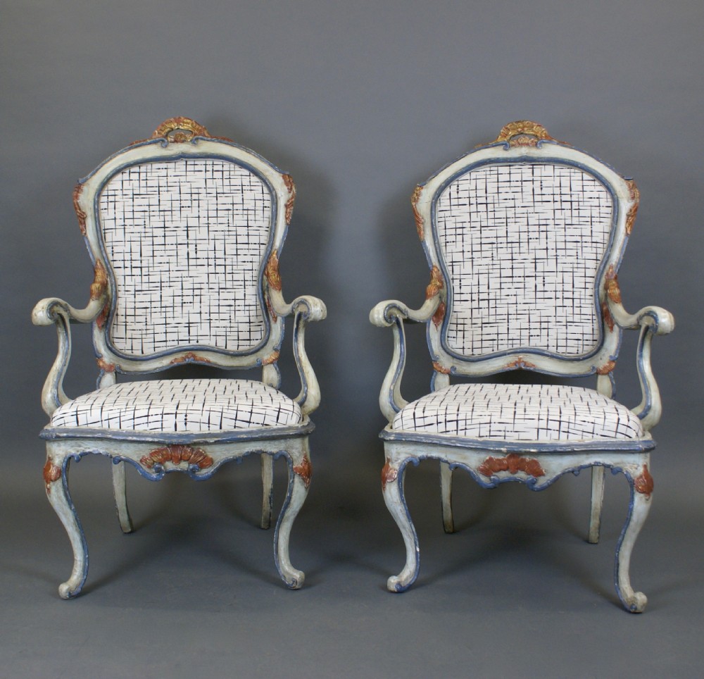 A pair of 18th-century Italian Barocchetto armchairs with pale blue carved wooden frames, red accents, and patterned fabric upholstery. View III