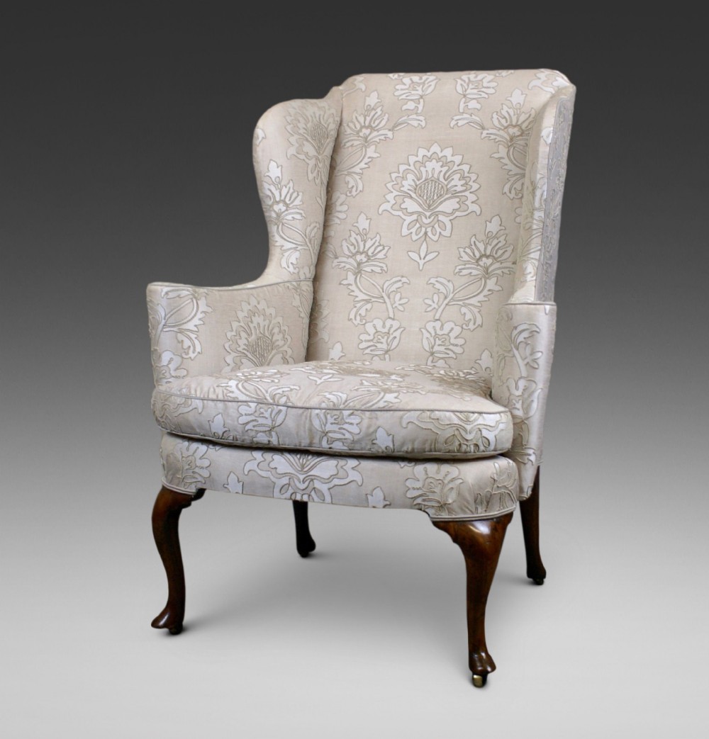 An 19th century walnut wing chair