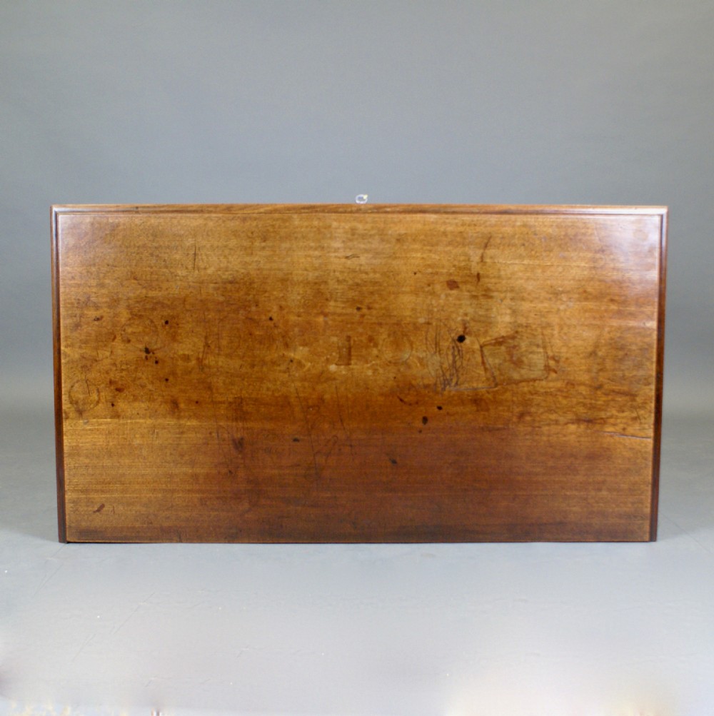 A Georgian mahogany chest of drawers featuring three small top drawers over three long graduating drawers with brass swan-neck handles and bracket feet. View VII