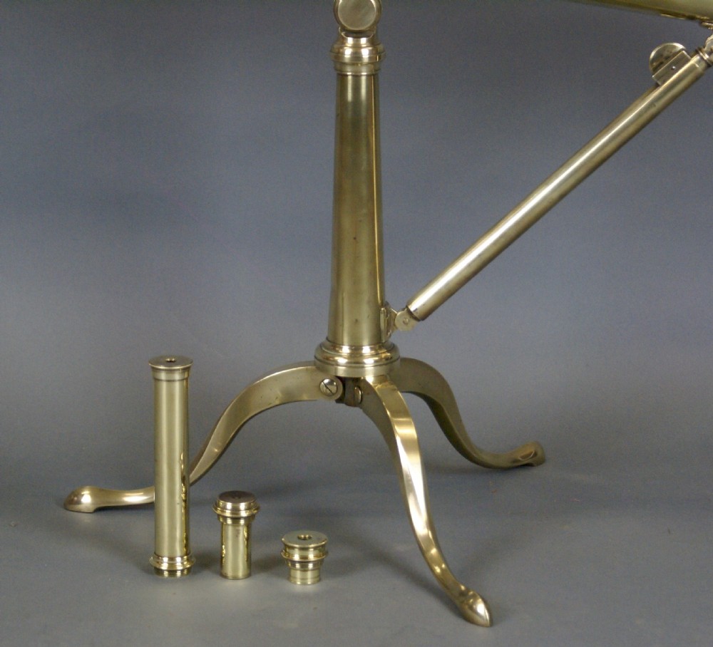 A nineteenth-century Victorian brass library telescope mounted on a tripod pillar stand alongside three additional brass eyepiece attachments. View VI